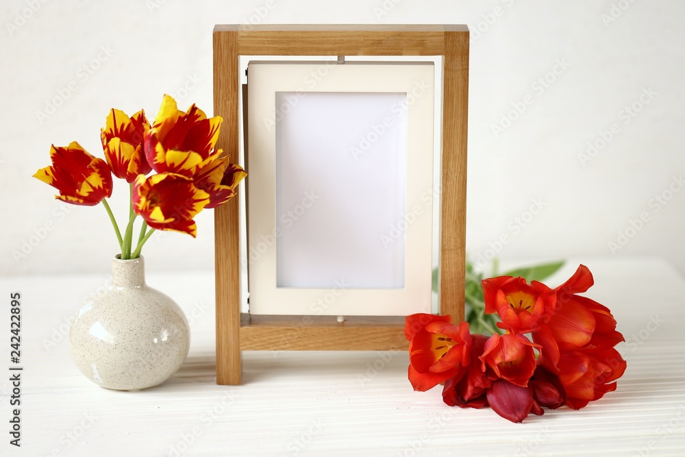 floral frame.Flower card. Wooden empty frame and red tulips on white wooden background.Mothers Day. International Women's Day. copy space. floral frame.Flower card. Wooden empty frame and red tulips on white wooden background.Mothers Day. International Women's Day. copy space.