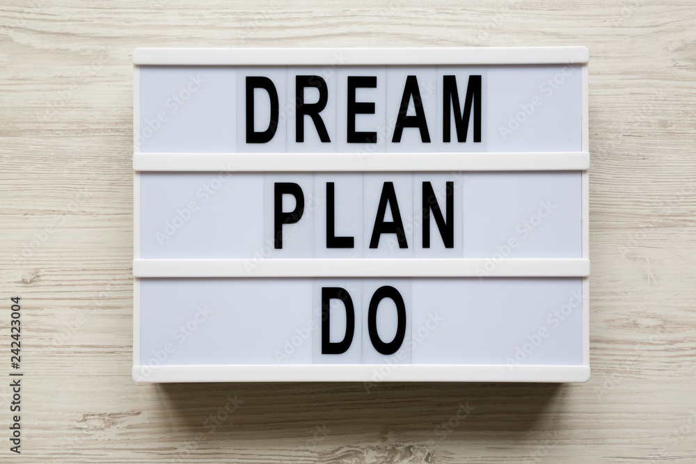 Lightbox with text 'Dream plan do' over white wooden background, top view. Business concept. From above, flat-lay, overhead. Lightbox with text 'Dream plan do' over white wooden background, top view. Business concept. From above, flat-lay, overhead.