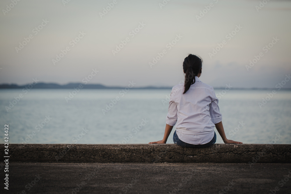 Women experience life problems sitting alone on the bridge.woman sad  alone 