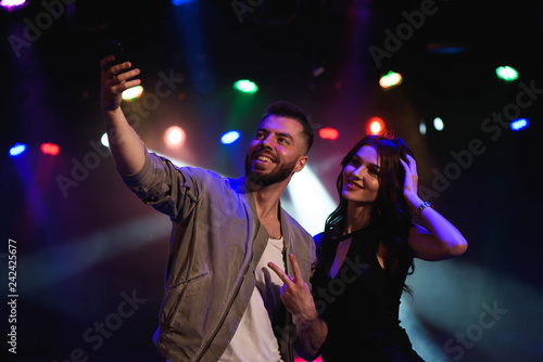 Couple take a selfie with a mobile in the night celebration