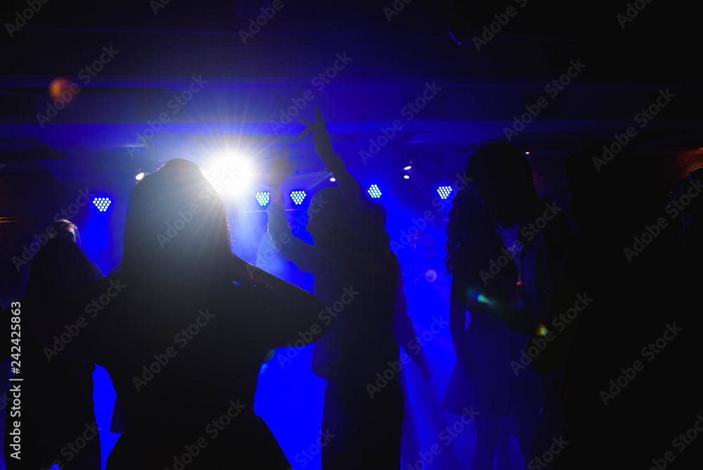 Dynamic young friends dancing at disco party Dynamic young friends dancing at disco party