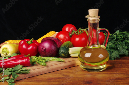 Fototapeta Naklejka Na Ścianę i Meble -    Vegetables and sunflower oil. On a black background.
