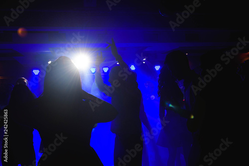 Dynamic young friends dancing at disco party © nagaets