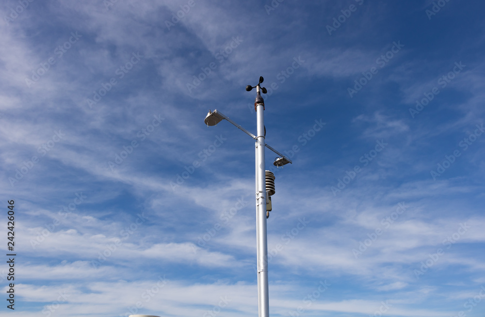 Many weather meter on white pole by the sky