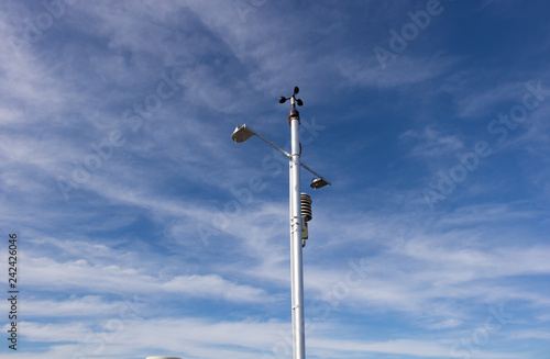 Many weather meter on white pole by the sky
