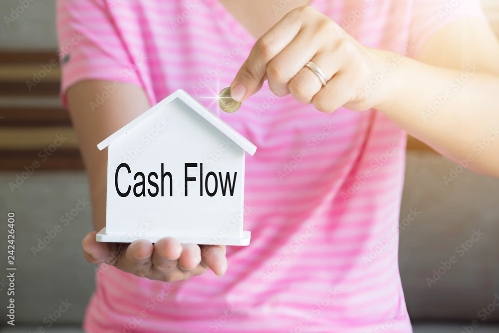 Φωτογραφία women hand putting money coin in piggy bank and cash flow word, Saving money concept