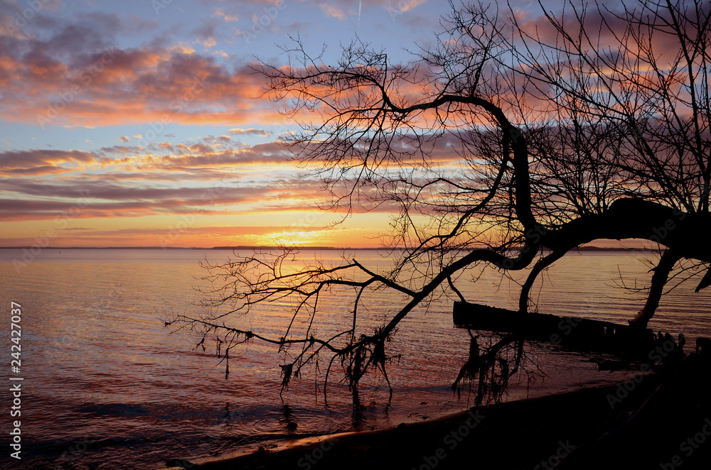 Sunset over the sea, clouds are illuminated in orange Sunset over the sea, clouds are illuminated in orange