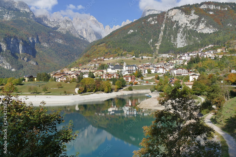 Molveno Lake and Molveno village panorama with Dolomites Mountains in the background