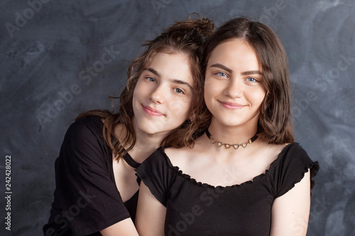 Portrait of two natural smiling teenage girls. Close up lifestyle portrait of two young girls best friends.