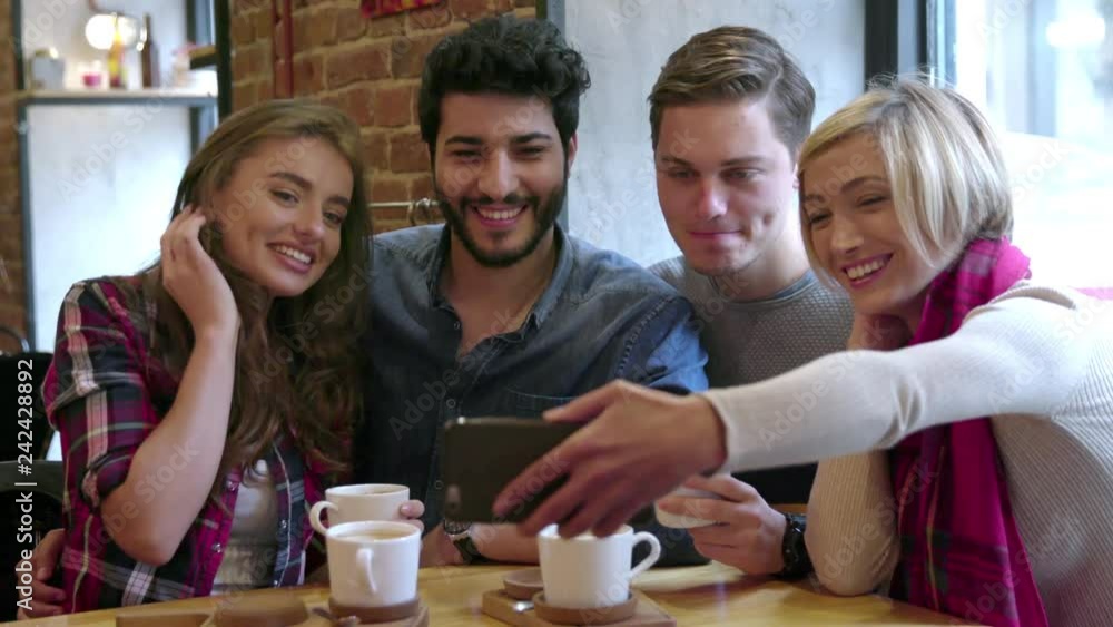 Happy Friends Making Video Call With Mobile Phone In Cafe Happy Friends Making Video Call With Mobile Phone In Cafe