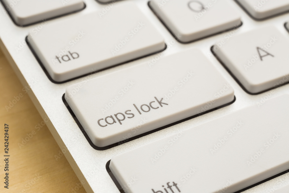 Close up caps lock button on white keyboard. Close up caps lock button on white keyboard.