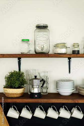 Dish on open shelves in kitchen