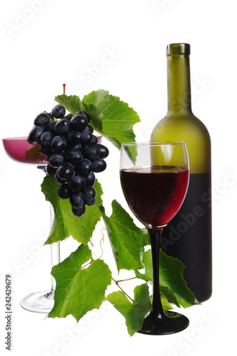 A glass of red wine and a bunch of grapes. Isolated on white