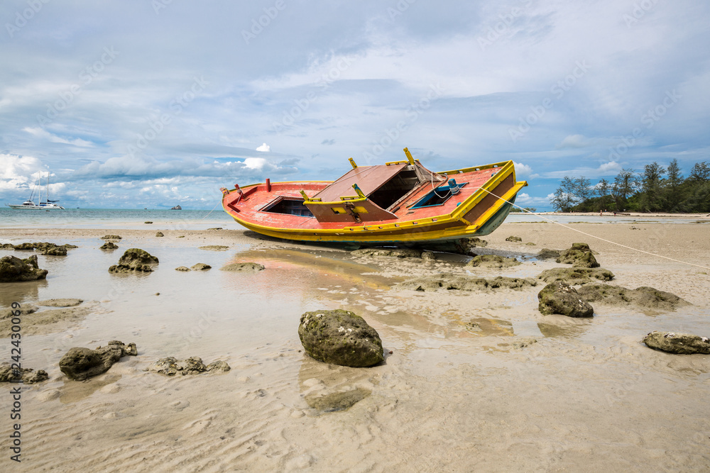 Old and broken wooden boat stranded on the sandy beach in Koh Samui island, Thailand Old and broken wooden boat stranded on the sandy beach in Koh Samui island, Thailand