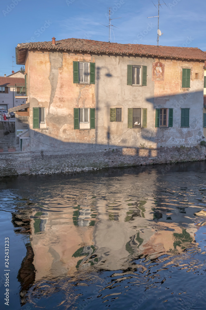 old  house recflects in Naviglio water, Bernate Ticino