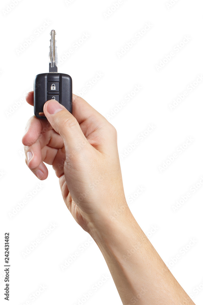 Hand holding a car key and pressing the unlock button, isolated on white background Hand holding a car key and pressing the unlock button, isolated on white background