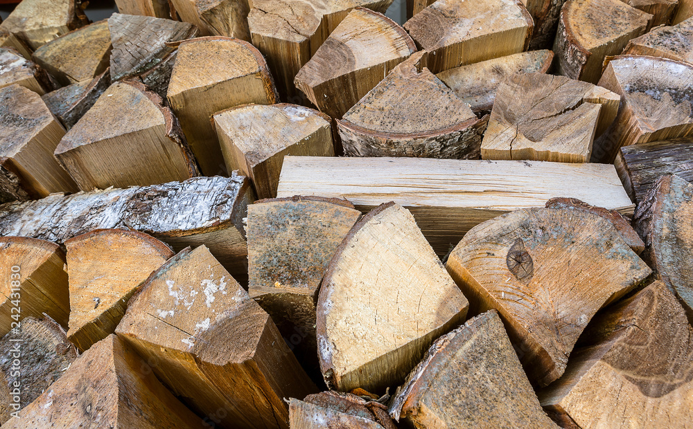 Natural wooden background. Firewood stacked and prepared for winter Natural wooden background. Firewood stacked and prepared for winter