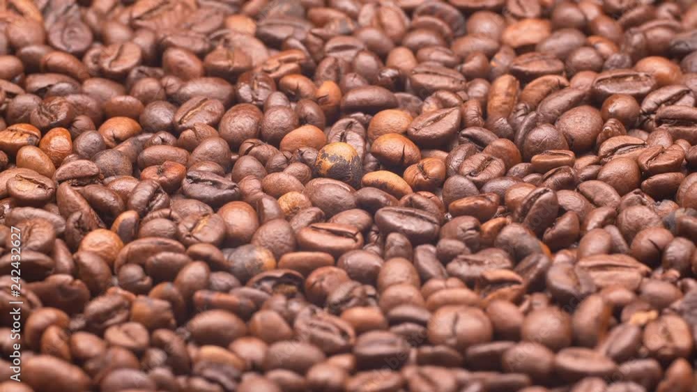 UHD closeup shot of the light roasted coffee beans on a turntable UHD closeup shot of the light roasted coffee beans on a turntable