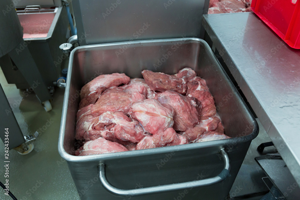 Large pieces of meat in the steel tank at the meat factory.