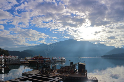 View of Sun Moon Lake with the passenger boats waiting at the numerous piers photo