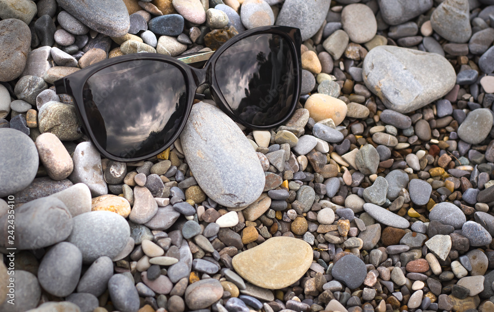 Funny photo with a face in sunglasses on the beach Funny photo with a face in sunglasses on the beach