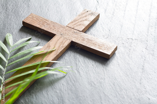 Easter wooden cross on black marble background religion abstract palm sunday concept
