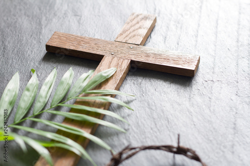 Easter wooden cross on black marble background religion abstract palm sunday concept
