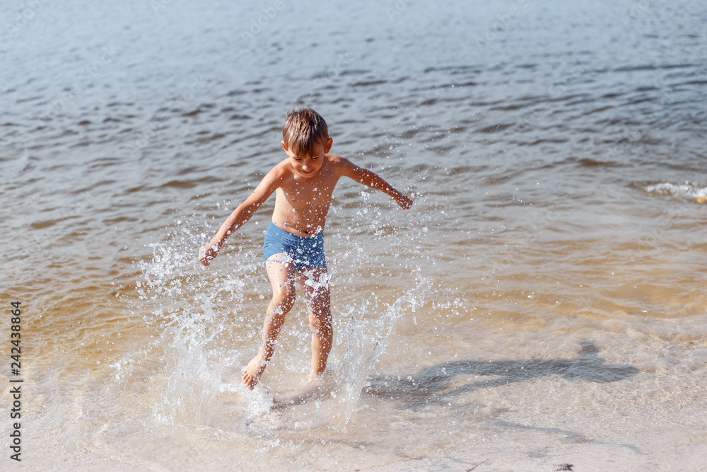 Boy splashing the water outside Boy splashing the water outside