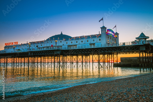 Brighton Pier beach with sunset golden hour at Sussex England, UK. Brighton Marine Palace and Pier popular place for visitor. photo