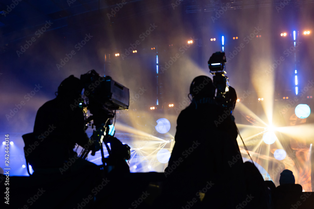 Television broadcast by a cameraman during a concert. Camera with the operator is on the high platform.