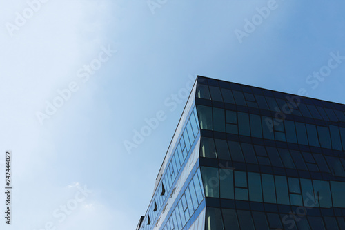 Modern glass business center building with blue sky on the background. Copy space.