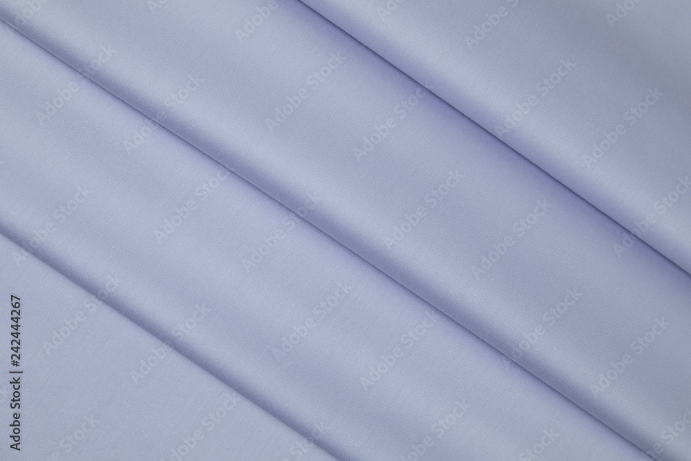 Obraz premium Lilac sateen fabric is laid by equal folds on diagonal