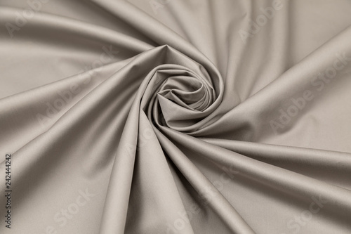 Foto Gray sateen fabric with steel gloss is laid by folds on diagonal to the center i