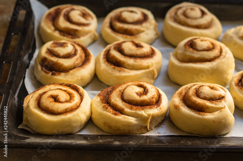 buns  with cinnamon - Cinnabon cooking process. (food background). copy space © Alesia Berlezova