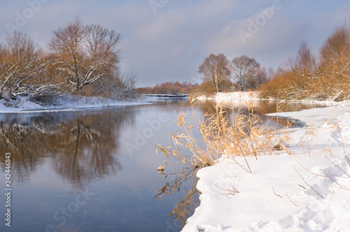 Winter river and snowy shore