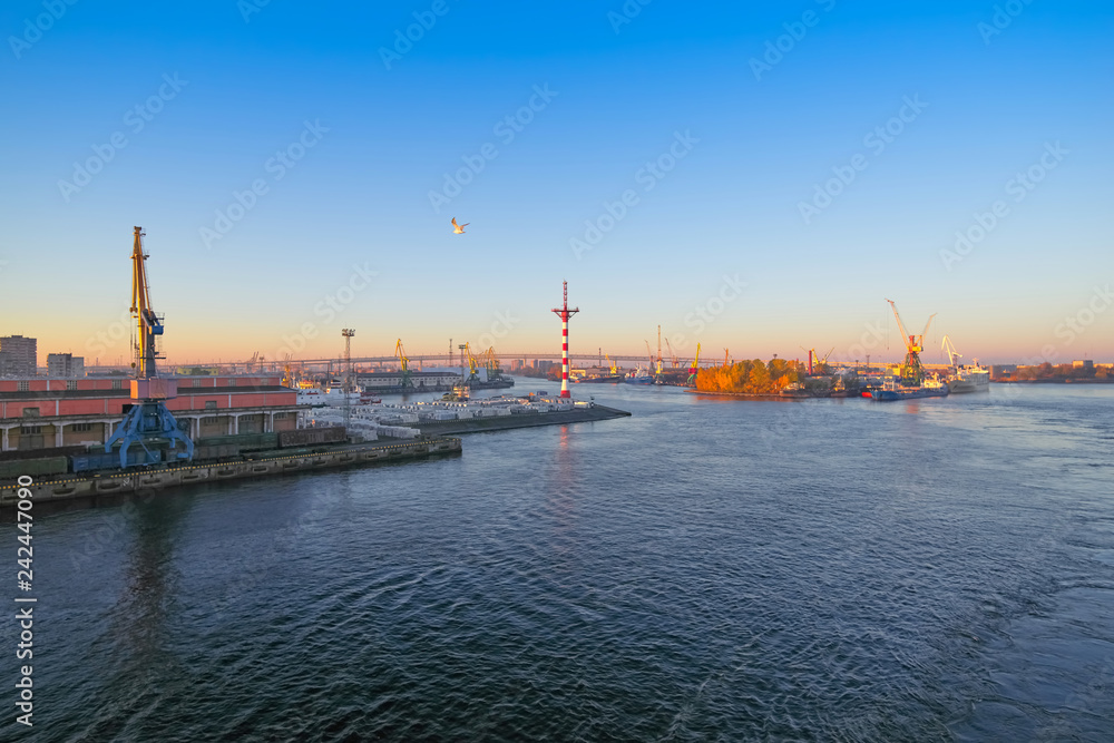 Sea cargo port, view of the water area and moorings with cranes, Sunrise early in the morning