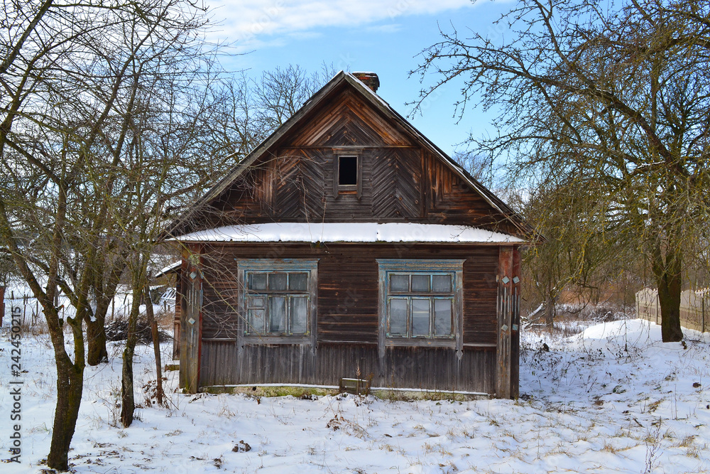 Ancient russian village. Old wooden empty house in snowy day