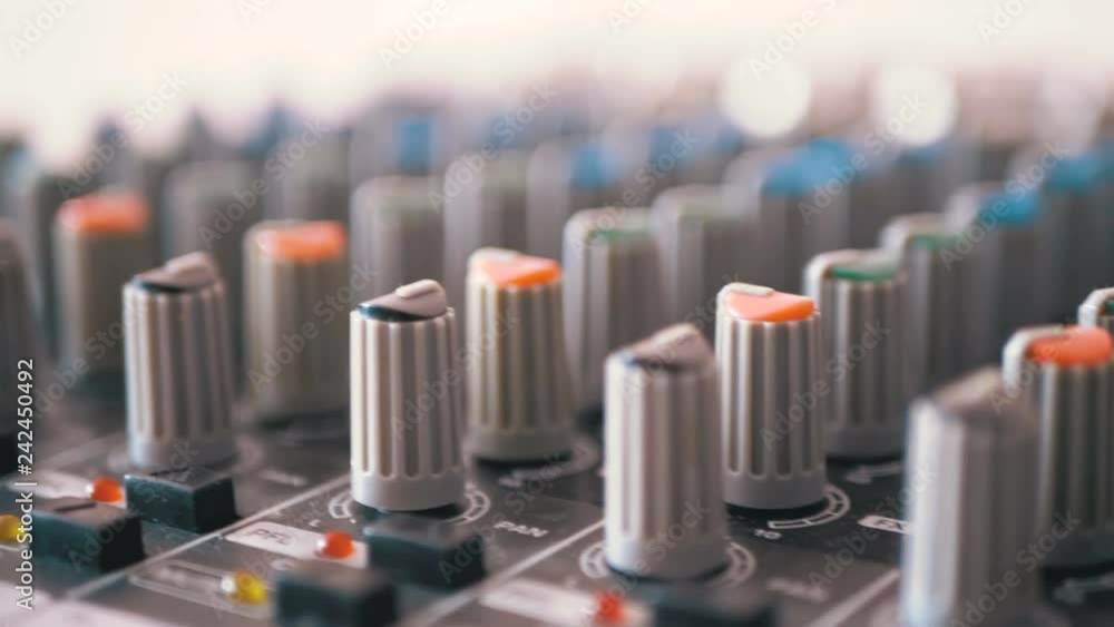 Control knobs on a sound mixing console. Fade sliders controls on audio