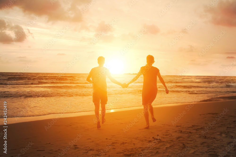 Happy couple in love run to sun on sea beach. Harmony relationship. Family vacation travel to tropical country. Beautiful sunset view. Honeymoon in Thailand.
