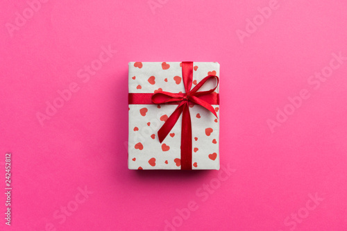 Background with gift box and hearts on pink Background. Top view with copy space for text