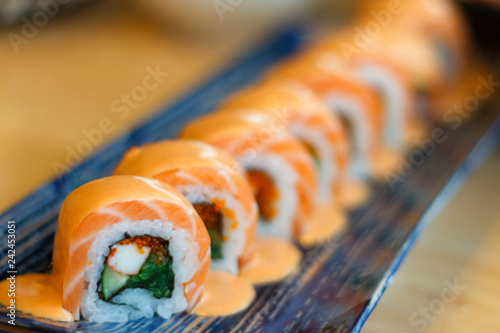 Japanese sushi rolls with cream cheese, salmon decorated.