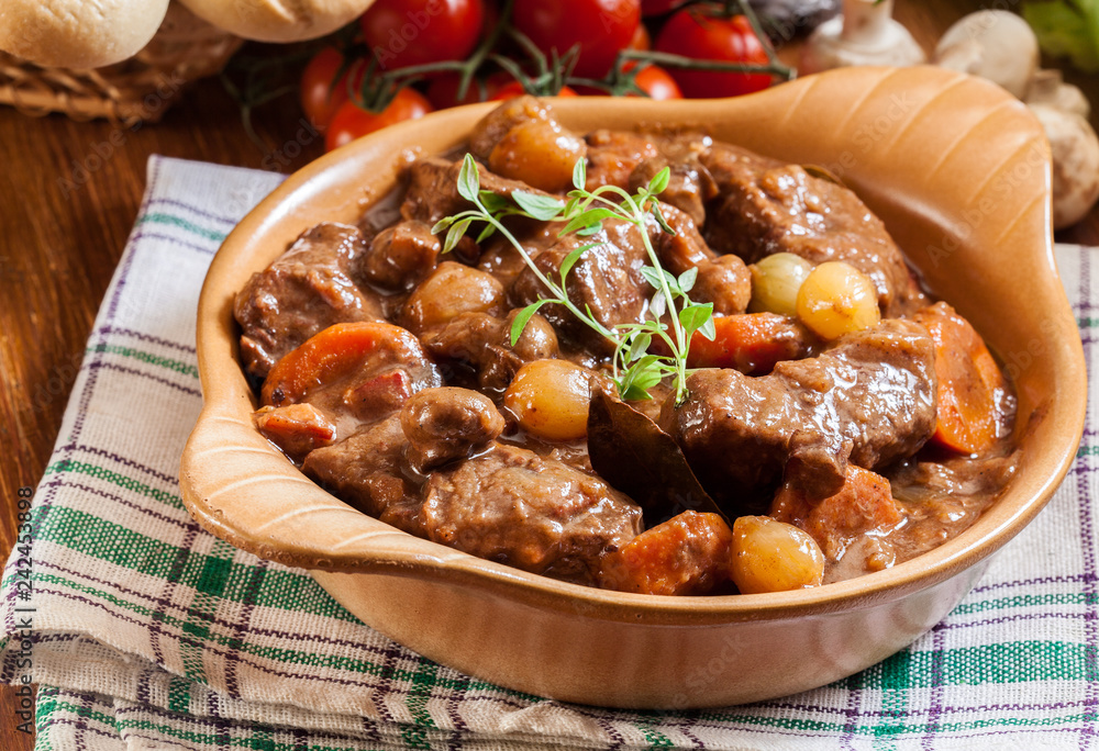 Beef Bourguignon stew served with baguette Beef Bourguignon stew served with baguette