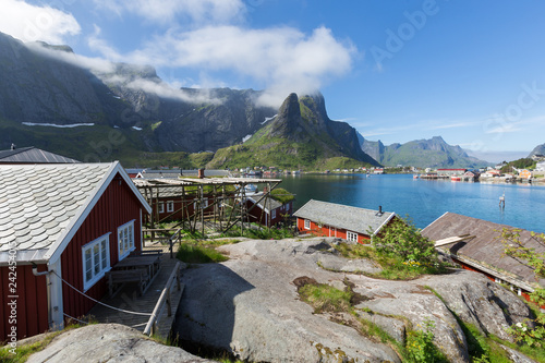View of mountains and Reine in Lofoten islands, Norway. Beautiful summer day and blue sky.