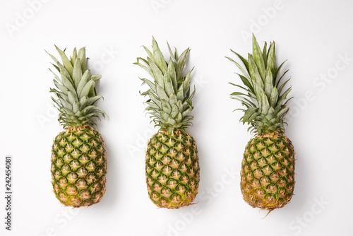 top view of tasty exotic pineapples on white  background