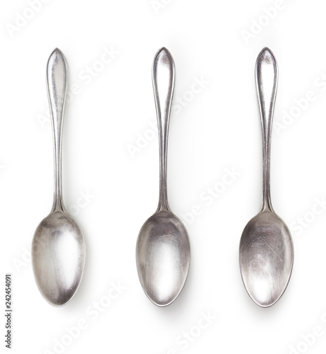 old silver spoon with different light isolated on white background with clipping path included, high angle view photo