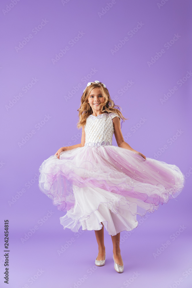 Full length portrait of a smiling cheerful pretty girl