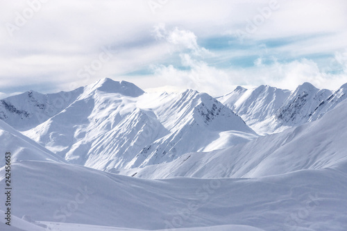 The peaks of snowy Caucasus mountains in The Gudauri Ski Resort, Georgia. Snowboarding in The Gudauri Ski Resort, Georgia. © Sokirlov
