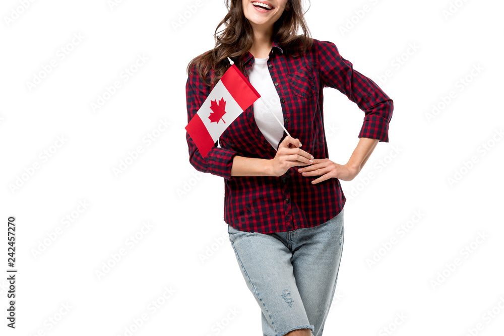 cropped view of woman with hand on hip holding canadian flag isolated on white cropped view of woman with hand on hip holding canadian flag isolated on white