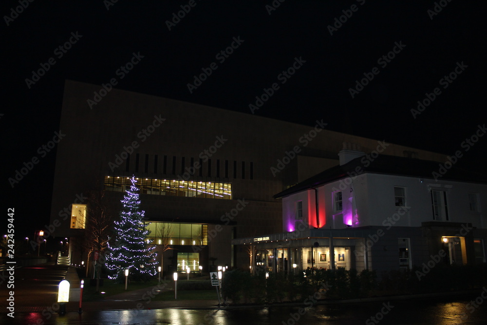 Dun Laoghaire, Ireland - December 05 2018: Lexicon Public Library lit for Christmas with the Cultural Center in the foreground