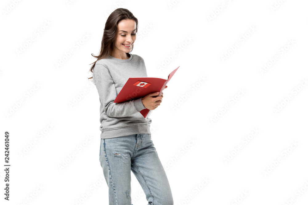 female student looking at red notebook with maple leaf sticker isolated on white female student looking at red notebook with maple leaf sticker isolated on white